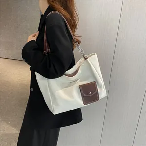 Minimalist beige canvas tote bag with brown PU pocket and metal chain strap for women