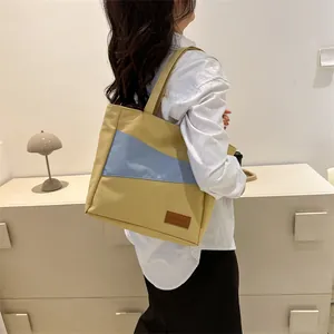 Seitenansicht einer großen Oxford-Stoff-Einkaufstasche im Gelb-Blau-Farbblock-Design