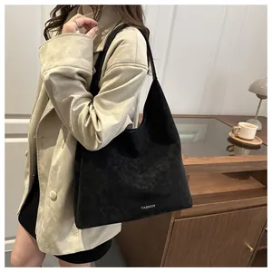 Vista dettagliata della grande borsa tote in pelle scamosciata nera in un outfit fashion