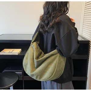 Olive green canvas tote bag shoulder view showing large capacity and soft corduroy texture