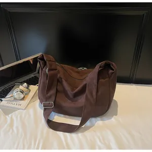 Detail of dark brown zebra canvas tote bag with wide strap and silver metal hardware