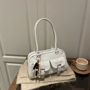 Weiße Boston-Tasche aus Lackleder mit Doppeltaschen und Quaste auf weichem Strick