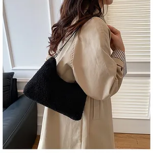 Detail of black faux shearling tote bag showing soft fuzzy texture and crescent shape