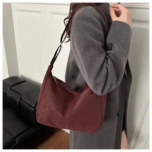 Detail of burgundy leopard print hobo bag with adjustable strap and suede texture