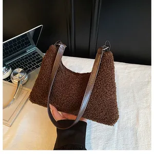 Detail of soft dark brown faux shearling shoulder bag with sleek leather straps