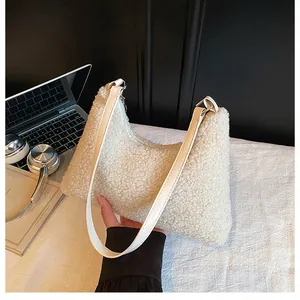 Detail of plush fleece shoulder bag showing soft lamb-like texture and leather strap