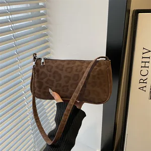 Chic brown leopard print faux suede baguette bag with sleek silver zipper detail