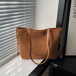 Retro caramel suede tote bag with drawstring tassel details and golden hardware