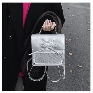 Detail of silver metallic backpack with bow ribbon and mesh pocket for display