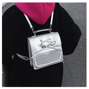 Detail of silver metallic PU backpack with ribbon bow and transparent mesh pocket