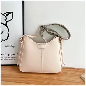 Detail of cream leather shoulder bag with ethnic style jacquard wide woven strap