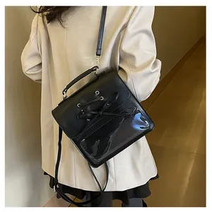 Cross-laced black PU crossbody bag with transparent PVC display window and top handle