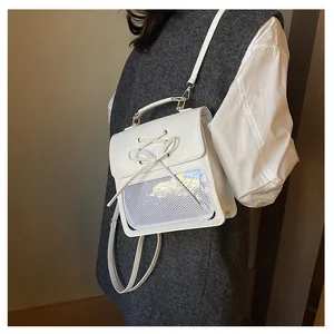 Detail of white PU leather itabag showing the lace-up bow and clear display window