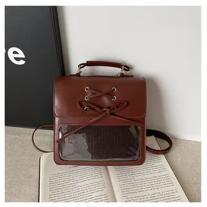 Detail of vintage school backpack with a transparent window and decorative bow tie