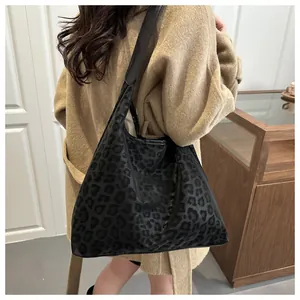 Large black leopard print PU leather tote bag shown on model for size and drape reference