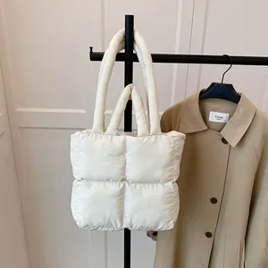 Minimalist white quilted puffer tote bag with thick padded handles for women