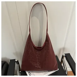 Close-up of wine red PU leather shoulder bag with subtle dark leopard print pattern