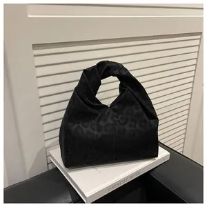 Close-up of leopard print tote bag featuring a unique knotted handle design and soft texture