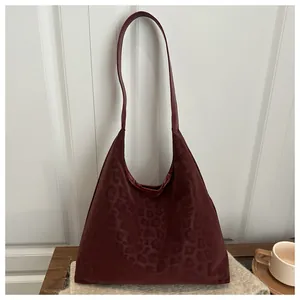 Close-up of deep red leopard texture on a soft PU leather hobo bag for women