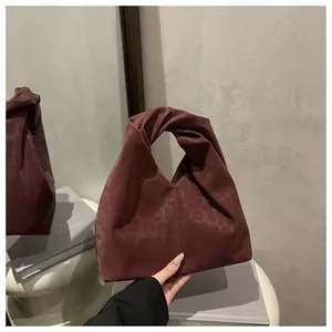 Close-up of the burgundy leopard print tote bag featuring a unique knotted handle design