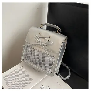 Silver PU leather bag with metallic finish featuring bow details and mesh pocket