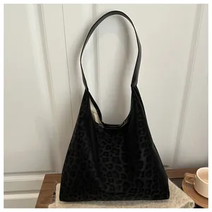 Detail of black leopard print PU shoulder bag with soft texture and leather handle
