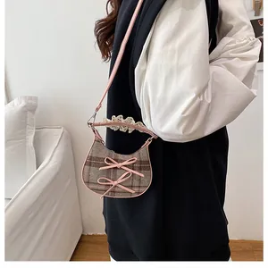 Detailed side view of mini leopard bow bag with pink leather trim and lace strap