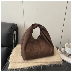 Detail of soft leopard print tote bag with knot handle design on cozy fabric