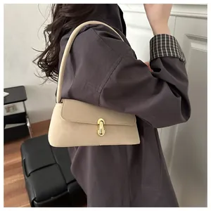 Detail view of beige shoulder bag with an elegant oval gold metal buckle closure