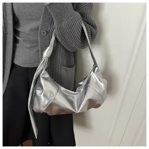 Detailed close-up of metallic silver hobo bag with a stylish side knot on the shoulder strap