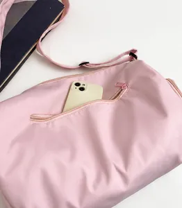 Pink lightweight travel bag detail showing the front hidden zipper pocket for smartphones
