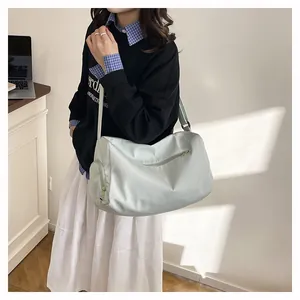 Mint green nylon yoga fitness bag with adjustable shoulder strap shown on a model