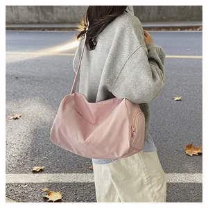 Detailed side view of the large pink nylon travel bag with side zipper and wide strap