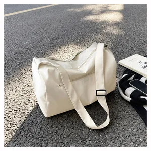 Detail of minimalist cream travel bag with adjustable strap and waterproof texture