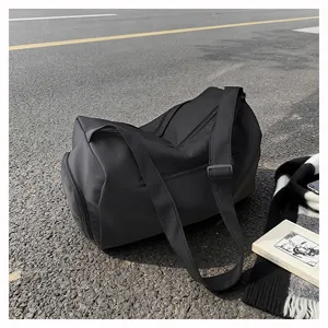 Detail of waterproof nylon fitness bag with separate shoe compartment on asphalt road