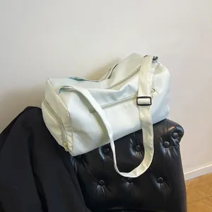 Minimalist light green travel bag with adjustable strap on a bench for gym and yoga