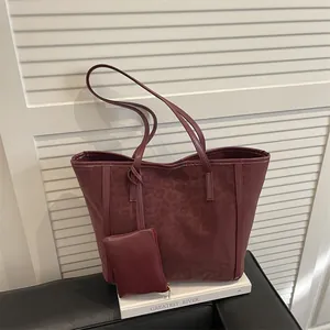 Retro burgundy leopard embossed tote bag with matching coin purse on white book