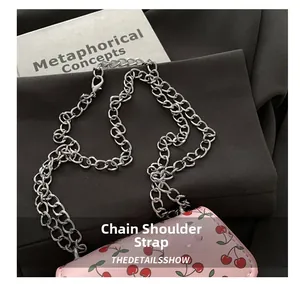 Detail der rosa Minitasche mit Kirschprint und einer polierten silbernen Metallketten-Schultergurt
