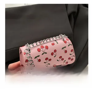Nahaufnahme der rosa Kunstledertasche mit Kirschmuster und silberner Kettenriemen