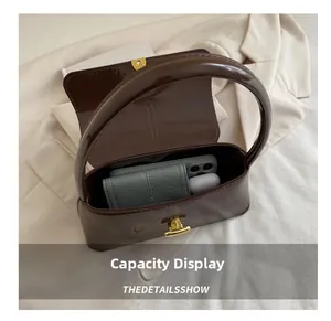 Detail view of the brown baguette bag interior showing capacity for phone and wallet