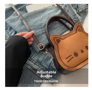 Close-up of adjustable gold buckle on brown cat-shaped crossbody bag strap