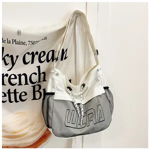 Detail of canvas tote bag with black mesh pockets and bold WERA letter printing