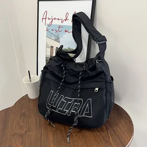 Black mesh tote bag with white ULTRA embroidery and adjustable shoulder strap for daily use