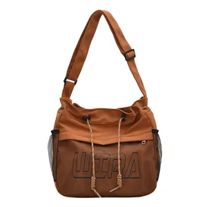 Brown nylon tote bag with mesh pocket and adjustable shoulder strap for casual commute