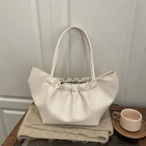 Minimalist cream white cloud bag with elegant pleated design and comfortable shoulder strap