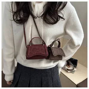 Mini leopard print crossbody bags in burgundy and dark brown with delicate top handles