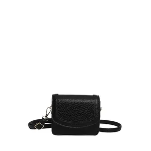 Minimalist black lychee texture leather shoulder bag with adjustable gold buckle strap