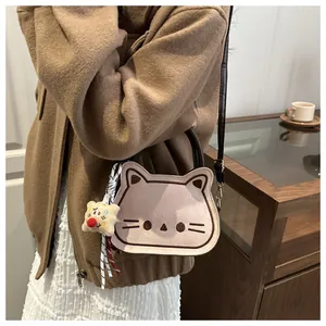 Close-up of pink cat embroidery bag with star charm and brown crossbody strap