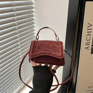Deep burgundy mini handbag with leopard print flap and adjustable shoulder strap