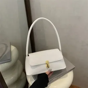 Chic white baguette shoulder bag with gold hardware clasp on minimalist background